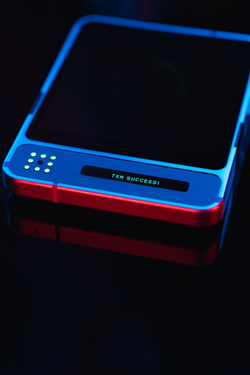 dGEN1 close-up showing LED matrix and terminal displaying TXN SUCCESS